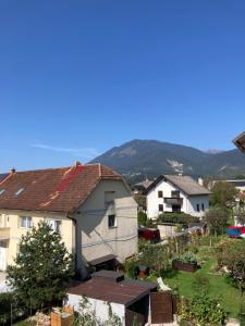 a group of houses with mountains in the background at Rural Carniola fairytale in Križe