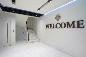a hallway with a welcome sign on a wall at Hestia - Romvis 9 in Athens