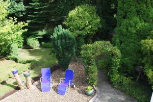 a group of blue chairs sitting in a garden at Haus Theene in Südbrookmerland