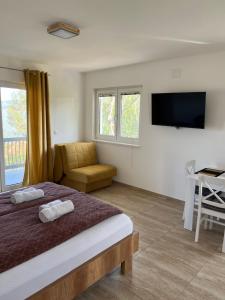 Postel nebo postele na pokoji v ubytování Apartmani PORTO
