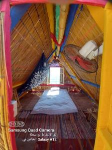 a small room with a bed in a tent at Perry’s Island Camp Al Mezina in Nuweiba