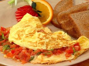 a white plate with an omelet and eggs and toast at Palm Star Motel in Fort Portal +26 photos