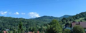 a view of a valley with trees and mountains at Chwilo Trwaj dom z jacuzzi i kominkiem z widokiem na góry Korbielów Pilsko in Korbielów +41 photos