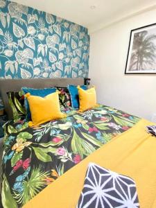 a bedroom with a bed with a colorful bedspread at The Waterbaby in Calstock