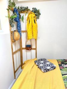 a room with a yellow bed and a shelf at The Waterbaby in Calstock