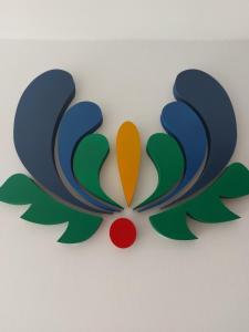 a colorful butterfly cutout on a white wall at Agroturystyka Zielone Wzgorze in Sikorzyno