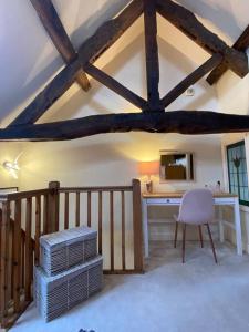 a attic room with a desk and a chair at The Old Stable in Shifnal