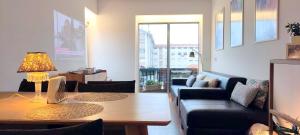 a living room with a table and a couch at IH Apartments & Studios in Espinho +107 photos