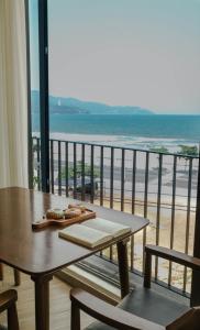 a balcony with a table and a view of the ocean at Anstay Beach Da Nang in Da Nang