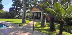 a house with palm trees and a parking meter at Matusadona Guest Lodge in Hillcrest