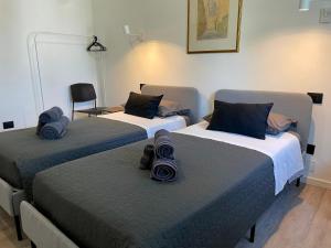 a room with two beds with blue pillows on them at Casa Silvano in Mestre