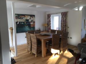 a dining room with a wooden table and chairs at An Mordros 15 Polkirt Heights in Mevagissey