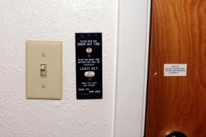a sign on a door that says leave left at Town House Motel in Winnemucca