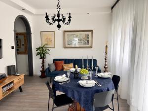 a living room with a table and a blue couch at Casa Silvano in Mestre