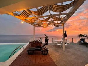 a villa with a pool and a view of the ocean at Fogo Boutique Hotel in São Filipe