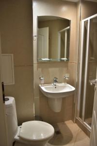 y baño con lavabo, aseo y espejo. en Apart Hotel Comfort, en Bansko