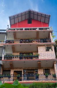 a tall building with balconies on the side of it at Bastola Basthan Homestay in Darjeeling