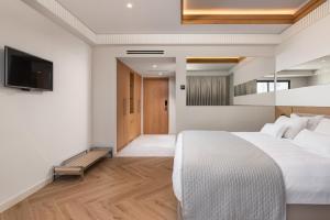 A bed or beds in a room at Mediterranean Hotel