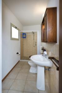 a bathroom with a sink and a toilet and a shower at Bivani a 100 m dal mare in Castellammare del Golfo
