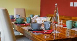 a wooden table with plates and cups on it at ABA-Sporting Apartment House in Leukerbad