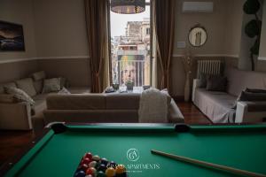 a living room with a pool table and a couch at Grandapartments via Duomo Napoli in Naples