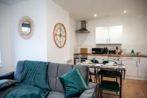 a living room with a couch and a table at Bv Charming 2-Bedroom Apartment by Kirkstall Shopping Centre, Free Parking in Leeds