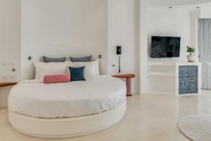 a large white bedroom with a large white bed at Ampersand Resort in Bophut 