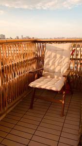 a white chair sitting on top of a balcony at Urban Sunset Loft in Bucharest