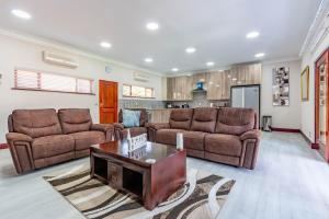 a living room with two couches and a coffee table at RSA Lodge in Benoni