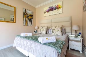 a bedroom with a bed with two towels on it at RSA Lodge in Benoni