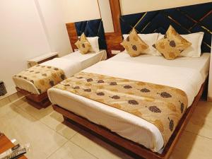 Postel nebo postele na pokoji v ubytování Hotel Maan Palace
