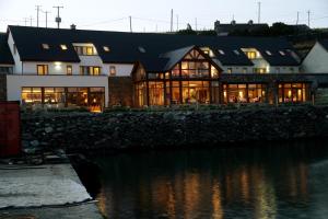 a large house with a lot of windows at Inishbofin House Hotel in Inishbofin