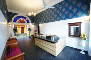 a lobby with a reception desk in a building at Pearl bell Villa in Pondicherry