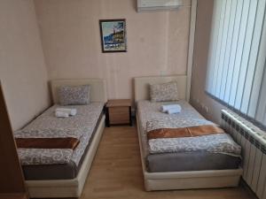 a room with two beds and a window at Hotel Saradis in Kruševac