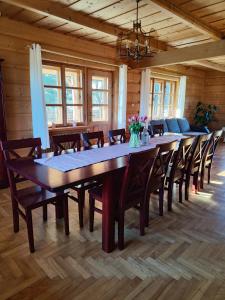 a large dining room with a long table and chairs at Na Bugaju in Czarny Dunajec