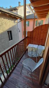 a patio with two chairs and a table on a balcony at BLA BLA in centro in Levico Terme