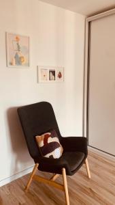 a black chair with a pillow in a room at Urban Sunset Loft in Bucharest