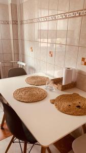 a white table with three baskets on top of it at Urban Sunset Loft in Bucharest