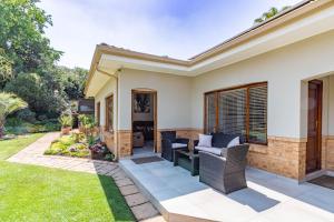 a home with a patio and lawn at RSA Lodge in Benoni