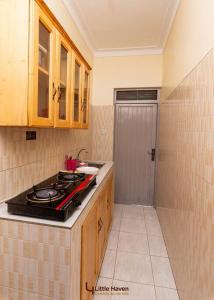 a kitchen with a stove and a counter top at Little Haven in Fort Portal