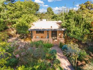 a house in the middle of a garden at Adorable Home Centrally Located! in Santa Fe