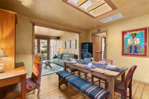 a living room with a wooden table and chairs at Adorable Home Centrally Located! in Santa Fe