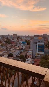 a view of a city at sunset from a balcony at Urban Sunset Loft in Bucharest