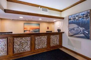 a lobby of a hotel with a wall with art at Econo Lodge Inn & Suites Foley-North Gulf Shores in Foley