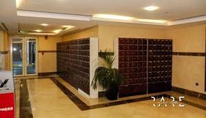 a room with a wall of wine bottles at RARE Holiday Homes - Deluxe Studio - Near City Center Mall - IMPZ - R2112 in Dubai