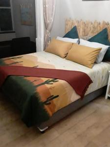 a bed with a painting of a horse on it at Beach Haven Sea Views, Fritzandi, Strand, Cape Town in Cape Town