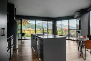 a kitchen with a sink and a bunch of windows at The View Bright - Apartment 2 in Bright