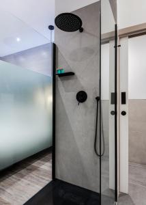 a shower with a glass door in a bathroom at Circlelet Luxury Private Suites in London +39 photos