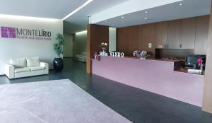 a lobby with a pink counter in a building at Hotel Monte Lírio in Espinho
