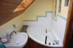 a bathroom with a large tub and a sink at Beechwood B+B in Fort William